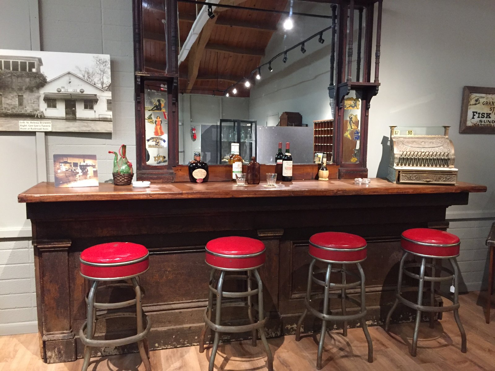 Historic carved wooden back bar with red-topped stools from Gee Gee’s Tavern.
