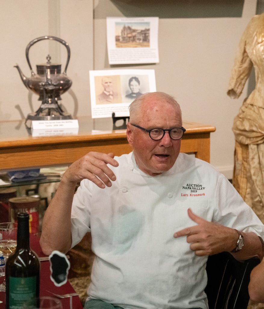Chef Lars Kronmark, in a white chef's coat, gestures while talking.
